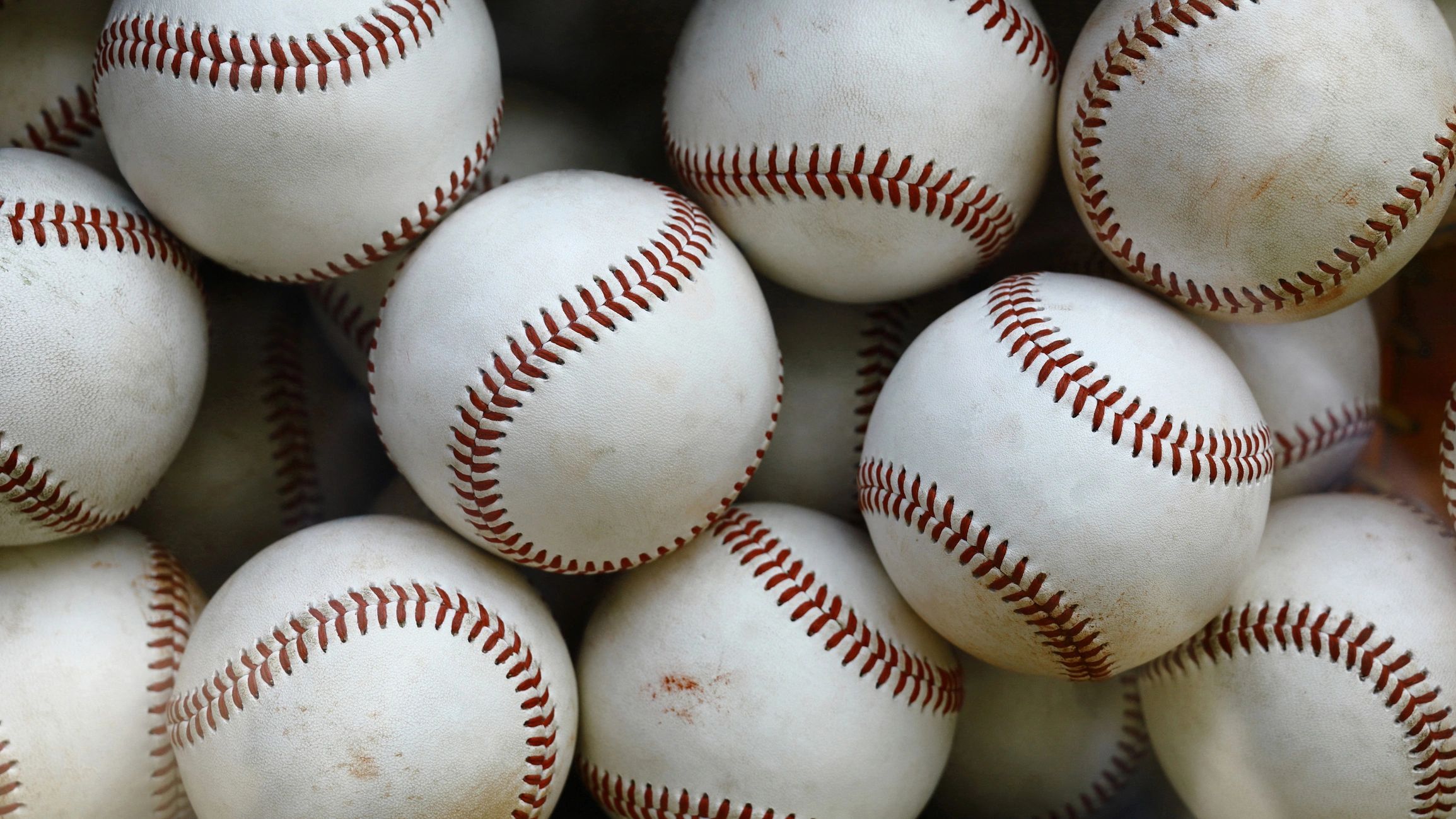 Basket of well-worn baseballs and softballs